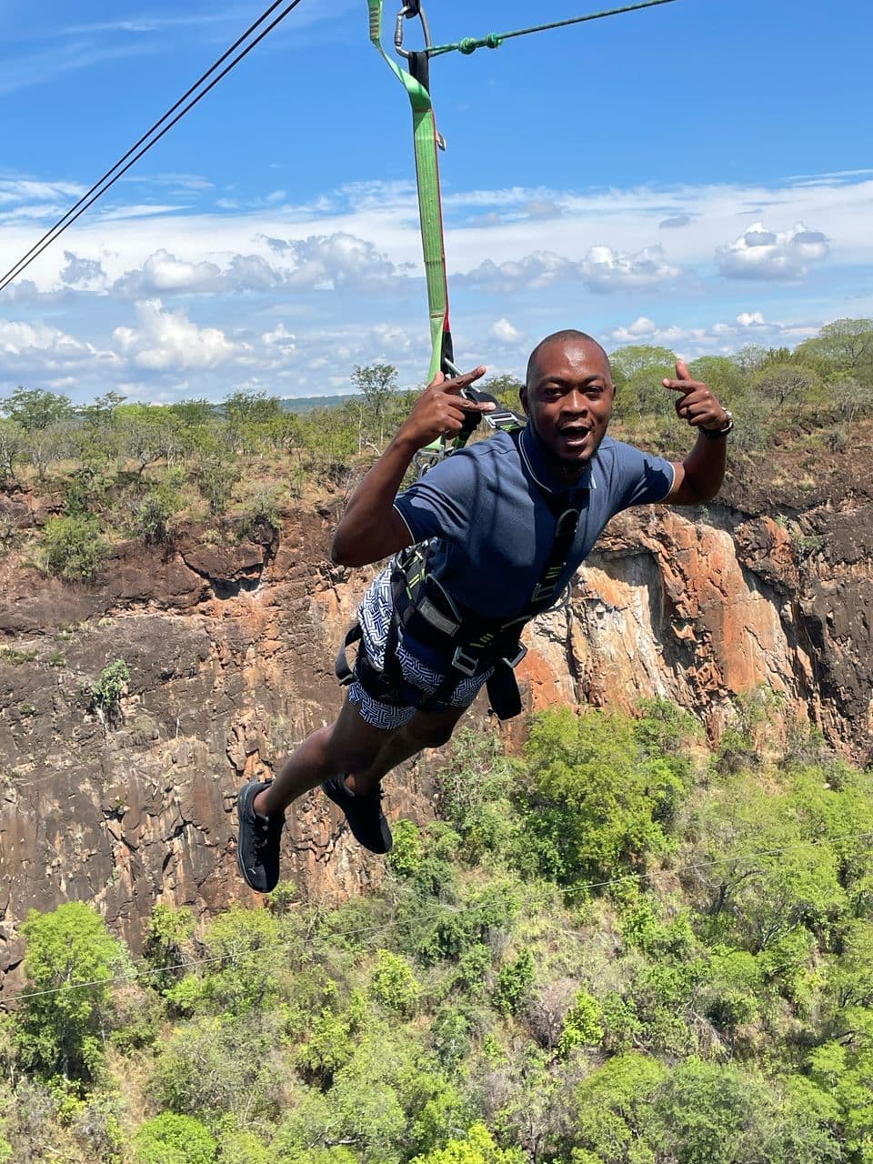 People swimming in the Devil's Pool at the edge of Victoria Falls